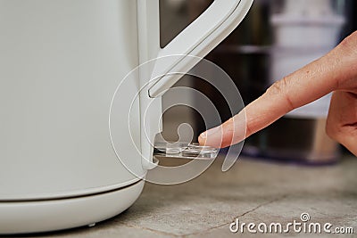 Turning on power button on electric kettle Stock Photo