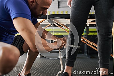 Close up personal trainer measuring calve with tape Stock Photo