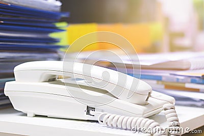 Close up of phone and a lots of unfinished documents on office desk Stock Photo