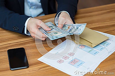 Close-up photo of businessman`s hands counting US dollars, man in business suit Stock Photo