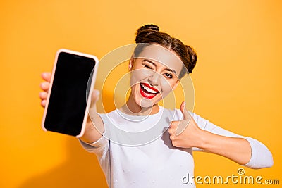 Close up photo of charming beautiful attractive lady offering suggesting recommending product raising her thumb up Stock Photo