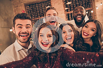 Close up photo of cheerful multiethnic group of fellows laugh scream have fun at christmas night x-mas party make selfie Stock Photo