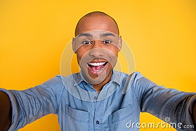 Close up photo of cheerful nice pretty youth laugh have weekend free time make photo moments isolated over yellow Stock Photo