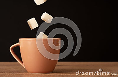 Close up photo of coffee cup and dropping sugers. concept of diabetes and overuse of sugar Stock Photo
