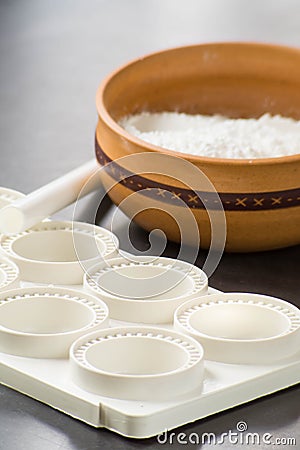 close up photo of cooking ingredients like a bowl of flour and mold of pasta Stock Photo