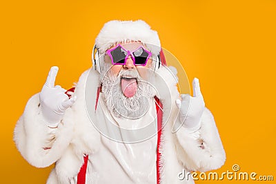 Close up photo of crazy funny hipster santa claus show horns sign tongue-out want rock-and-roll concert instead x-mas Stock Photo