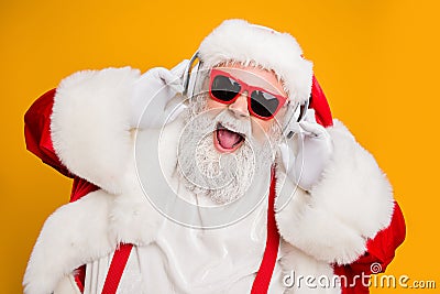 Close up photo of crazy funny santa claus listen music on modern headset celebrate christmas time noel party wear red Stock Photo