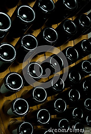 Close up photo of dark bottles of wine laying underground, winery autumn concept Stock Photo