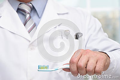 Close up photo of dentist holding toothbrush Stock Photo