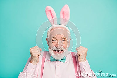 Close up photo of funky excited positive retired gentleman celebrate traditional easter event raise fists enjoy victory Stock Photo