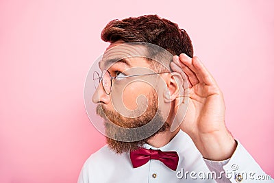 Close-up photo of funny funky smart concentrated hipster gentleman holding palm near ear catching familiar sound Stock Photo