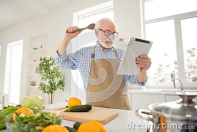 Close up photo grey haired he his him grandpa hands arms e-reader sorry guilty face wrong ingredient afraid scared of Stock Photo