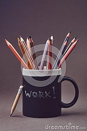 Close-up photo of a group multicolored pencils in black mug. Stock Photo