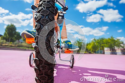 Close-up photo of the little bicycle wheel and boy push pedals Stock Photo