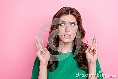 Close up photo of nice upset lady fingers crossed hope wish luck wear trendy green outfit empty space isolated on pink Stock Photo