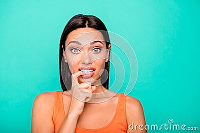 Close up photo portrait of depressed negative expressing nervous girl biting nails damaging new manicure isolated pastel Stock Photo