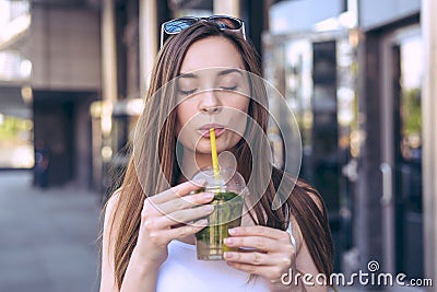 Close up photo portrait of nice glad charming beautiful funny funky cheerful cute pleased with closed eyes enjoying cool ice tea Stock Photo