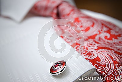 Close-up photo of stud on white shirt with red tie Stock Photo