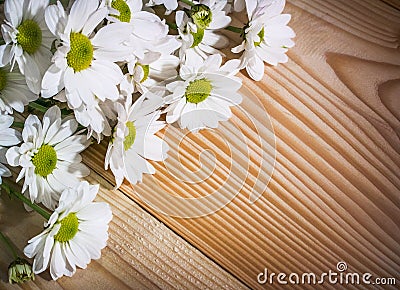 Close-up photo of the white flowers in the upper left corner on the background of wood Stock Photo
