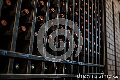 photo of wine bottles stacked on wooden racks in cellar Editorial Stock Photo