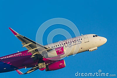 Close-up photo of a wizzair plane on the sky Editorial Stock Photo