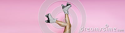 Close up photo of woman's body part. Legs wearing glamour silver glitter roller skates Stock Photo