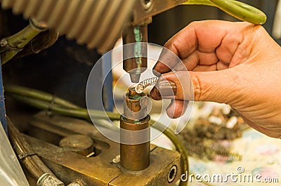 Close-up photo of woman`s hand electronically welding a part Stock Photo