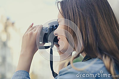 Close up photo of woman taking picture on her digicam for having happy memories of an old city, beauty fashion lifestyle leisure f Stock Photo