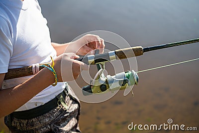 Close-up photo of a young boy fishing outdoors on a summer day. Stock Photo