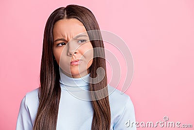 Close up photo of young pupil girl unhappy doubt looking empty space isolated on pastel pink color background Stock Photo