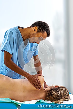 Close up of physiotherapist manipulating body part on young woman. Girl laying on madical bed Stock Photo