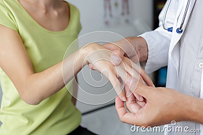Close-up physiotherapist massaging palm woman Stock Photo