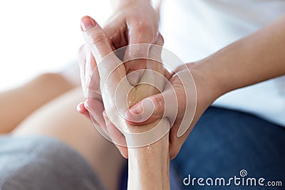 Physiotherapist pressing specific spots on female palm. Stock Photo