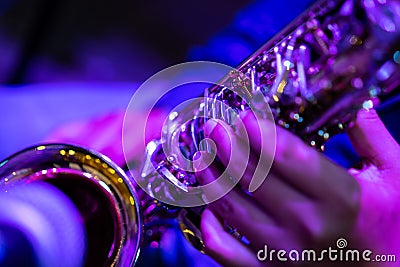 A close up picture of a artist is playing saxophone in the church Stock Photo