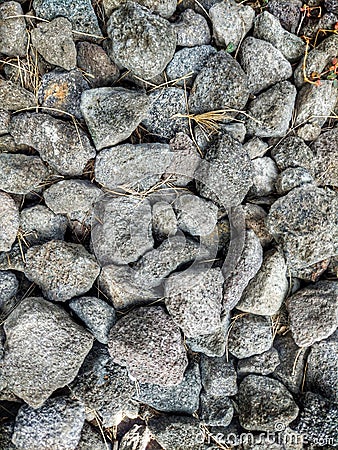 A close up picture of a pile of grey stones on the ground Stock Photo