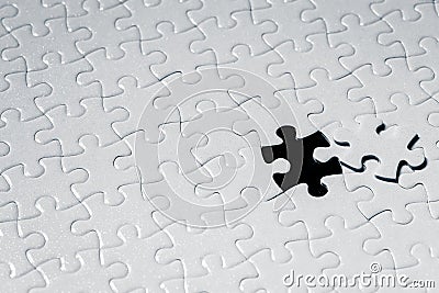 Close up piece of white jigsaw puzzle Stock Photo