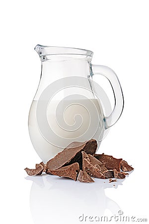 Close-up pieces of chunk black chocolate with glass jug of milk Stock Photo