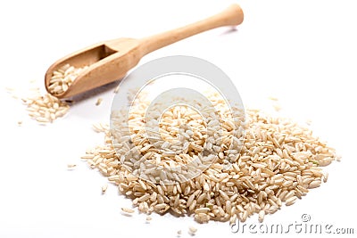 Close-up of pile of brown rise in a wooden spoon on white background Stock Photo