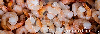 Close-up of a pile of frozen orange shrimps. Peeled shrimp, leaving only tails. Natural seafood background Stock Photo