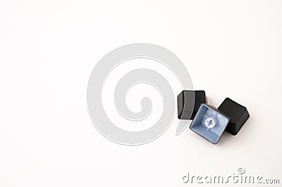 A close-up of a pile of three detached mechanical keyboard keycaps on a white isolated background. Copy space Stock Photo