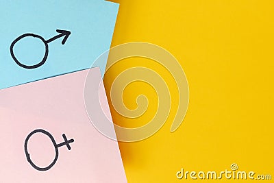 Stickers with gender symbols Venus and Mars indicate man and woman above yellow background. Heterosexuality Stock Photo