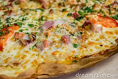 Close-up of pizza with ham, cheese, tomatoes and herbs and bacon. Food background Stock Photo