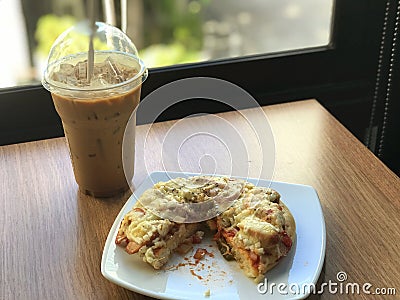 close up pizza pice paste on white dish and ice coffee Stock Photo