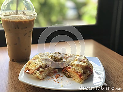 close up pizza pice paste on white dish and ice coffee Stock Photo