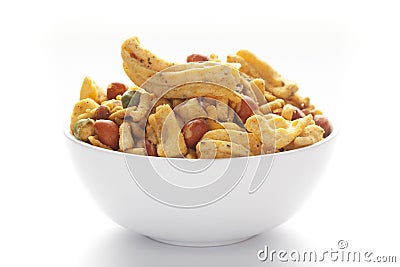 Close up of plane salty Golden Mixture Indian namkeen snacks on a ceramic white bowl. Stock Photo