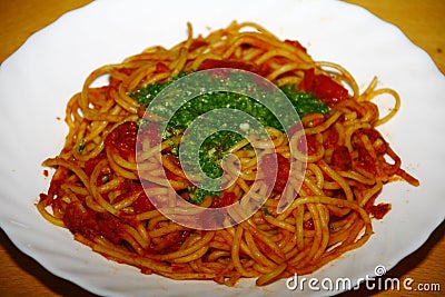 Plate with pasta, tomatosauce, basil and other herbs seafood Stock Photo