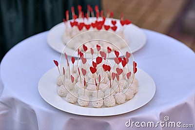 White wedding cake pops with red hearts Stock Photo