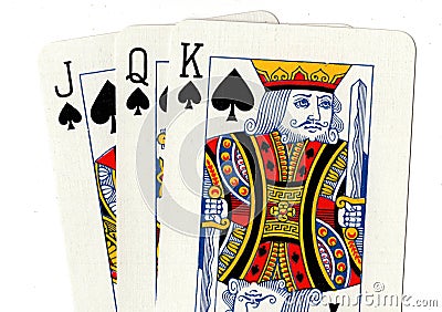 A close up of playing cards showing a jack, queen and king of spades. Stock Photo