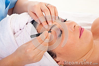 Close up of plucking eyebrows Stock Photo