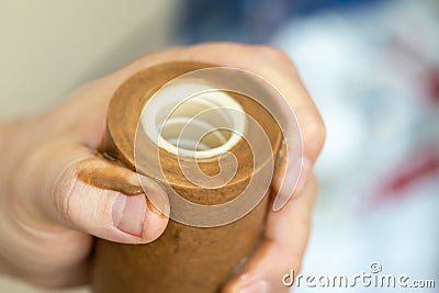 Close-up plumber hand holding used dirty rusty first-stage filter for drinking water. Changing cartridge of home sanitary Stock Photo